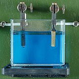 The copper from the aqueous solution of the copper sulfate (CuSO4) precipitates on the cathode